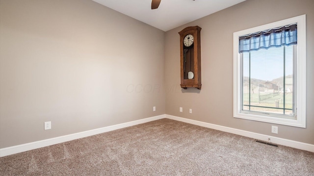 empty room with carpet and ceiling fan