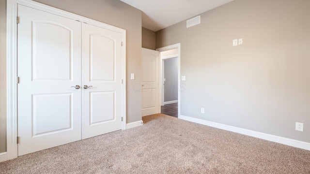 unfurnished bedroom with carpet floors and a closet