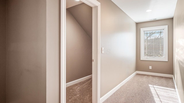 hallway with carpet floors