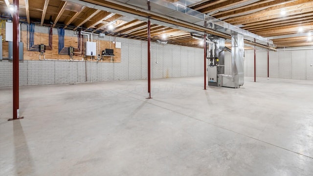 basement featuring electric panel and heating unit