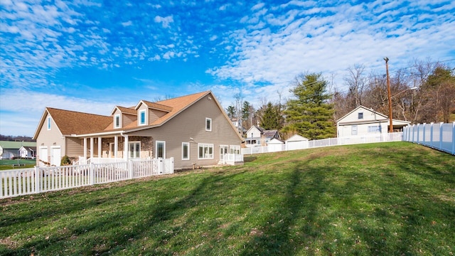 rear view of house featuring a yard