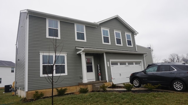 view of front facade featuring a garage and cooling unit