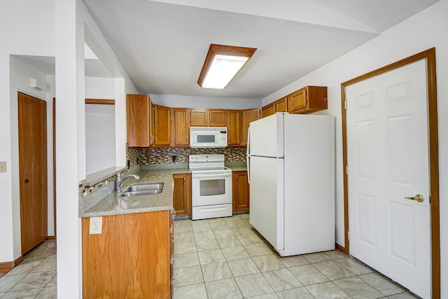 kitchen featuring decorative backsplash, sink, white appliances, and light stone countertops