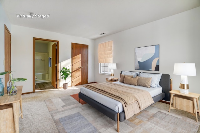 carpeted bedroom featuring ensuite bathroom