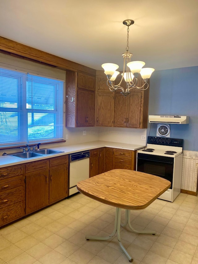 kitchen with electric range oven, sink, white dishwasher, hanging light fixtures, and a notable chandelier