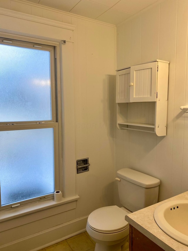 bathroom featuring toilet, vanity, and tile patterned flooring