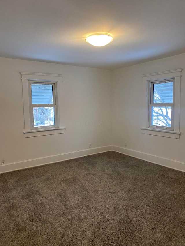 carpeted empty room with plenty of natural light