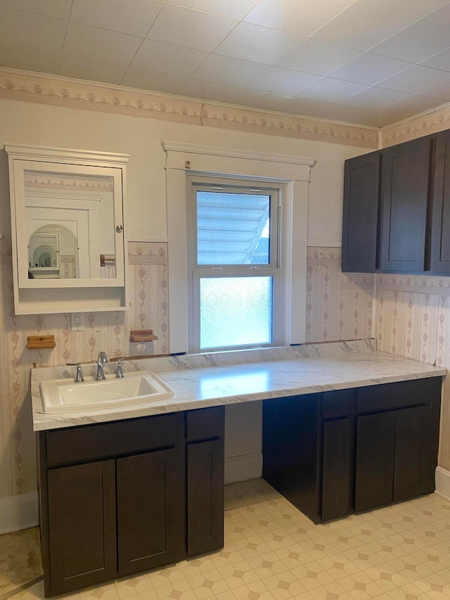 kitchen featuring ornamental molding and sink