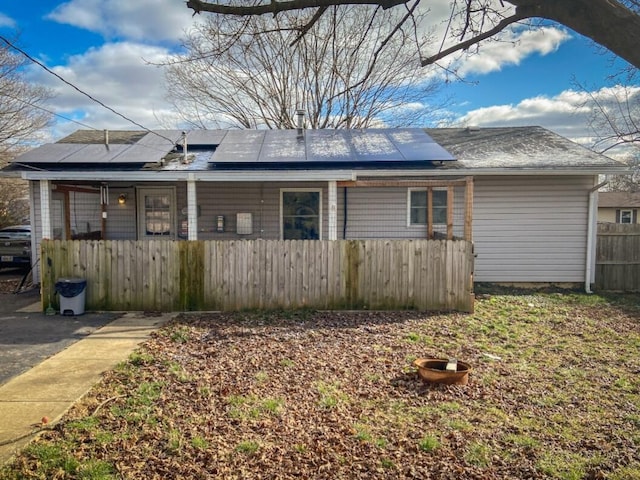 view of front of property featuring covered porch and solar panels