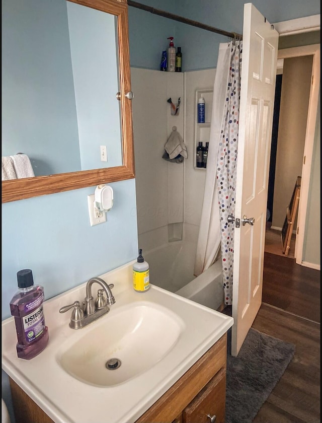 bathroom featuring vanity, wood-type flooring, and shower / tub combo