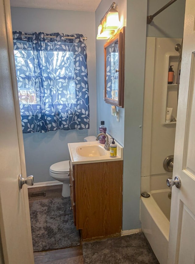 full bathroom with shower / tub combination, vanity, hardwood / wood-style flooring, and toilet