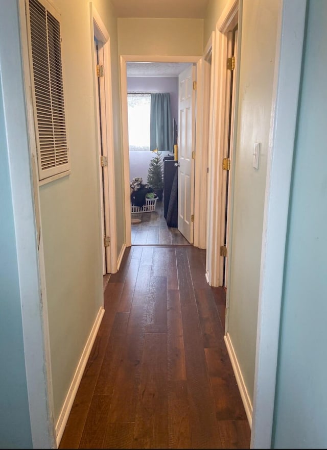 corridor with dark wood-type flooring