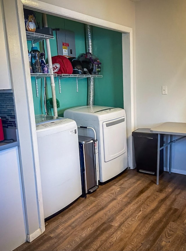 laundry area with washing machine and dryer and dark wood-type flooring