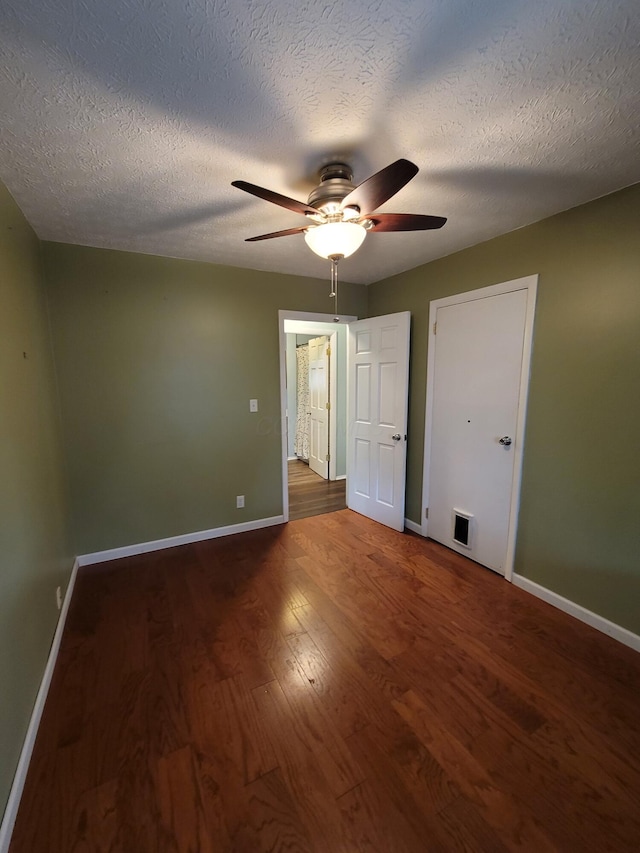 7358 Roshon Ave, Reynoldsburg, OH 43068 - unfurnished bedroom with baseboards, wood finished floors, a ceiling fan, and a textured ceiling