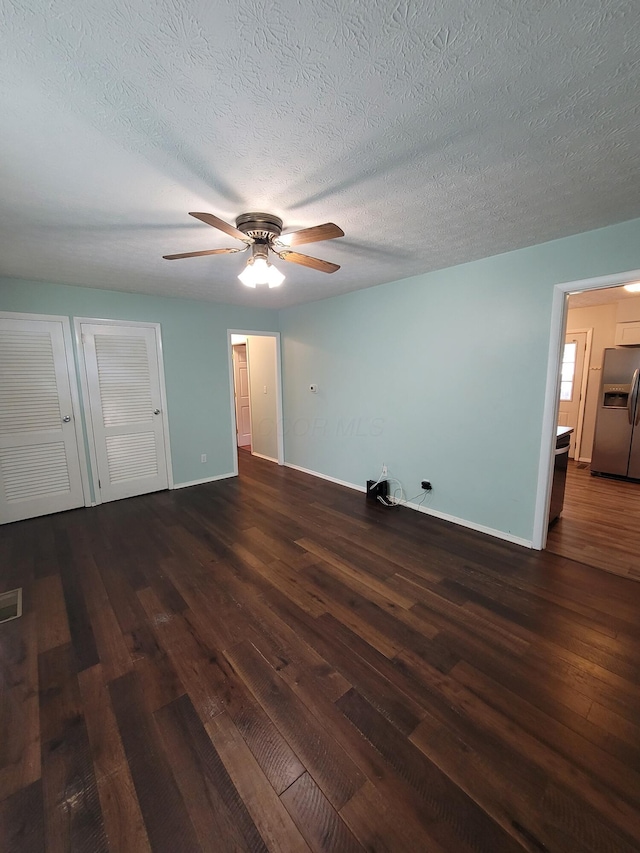 7358 Roshon Ave, Reynoldsburg, OH 43068 - unfurnished bedroom featuring stainless steel refrigerator with ice dispenser, wood-type flooring, baseboards, a textured ceiling, and ceiling fan