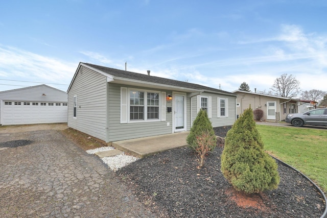 view of front of house featuring a garage and an outdoor structure