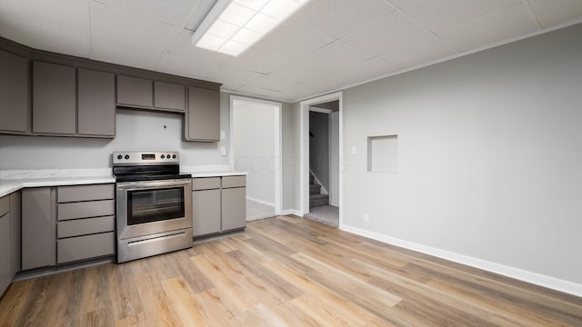 kitchen with electric range, light hardwood / wood-style floors, and gray cabinets