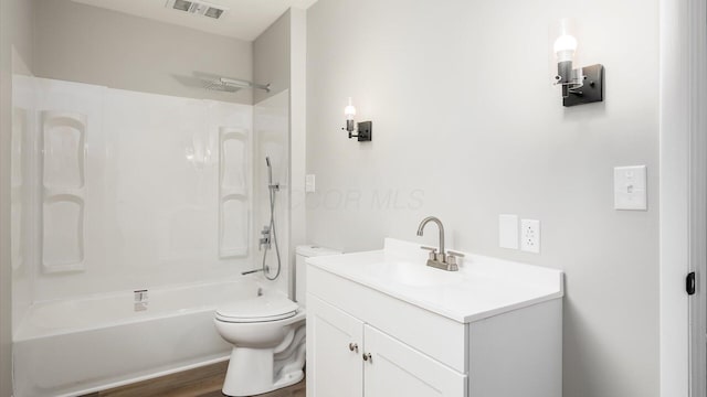 full bathroom featuring toilet, hardwood / wood-style floors, vanity, and bathing tub / shower combination