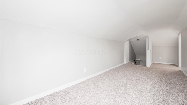 bonus room featuring carpet and lofted ceiling