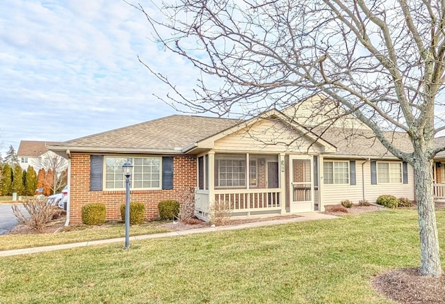 view of front of home with a sunroom and a front yard