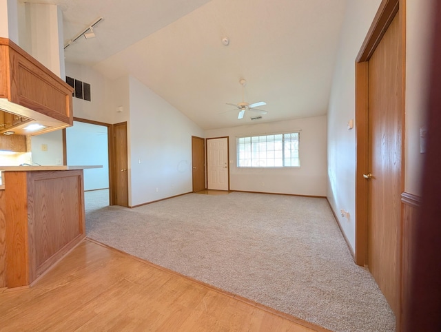 interior space featuring lofted ceiling, ceiling fan, and track lighting