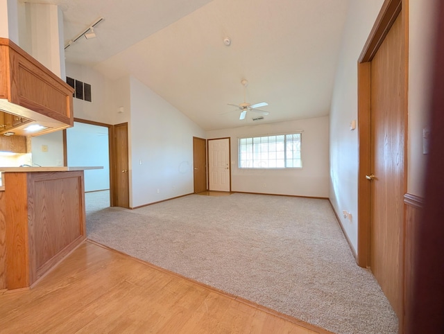388 Virginia Ct, Pataskala, OH 43062 - unfurnished living room with ceiling fan, light wood-style flooring, high vaulted ceiling, light carpet, and track lighting