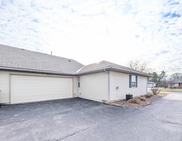 388 Virginia Ct, Pataskala, OH 43062 - view of side of home with driveway, a garage, and a shingled roof
