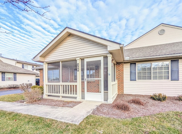 view of front of home featuring a sunroom