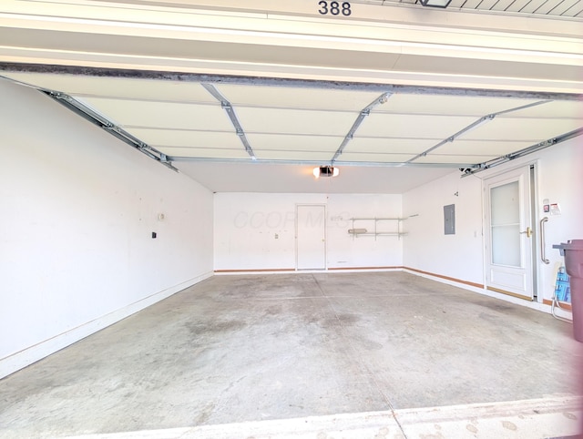 garage with electric panel and a garage door opener