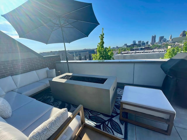 view of patio with an outdoor living space with a fire pit