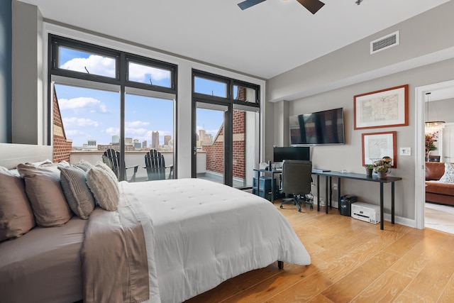 bedroom with light hardwood / wood-style floors and ceiling fan