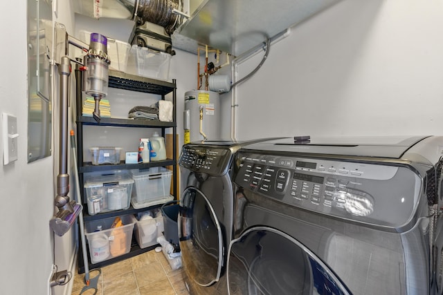 washroom featuring washer and dryer, electric water heater, and tile patterned flooring