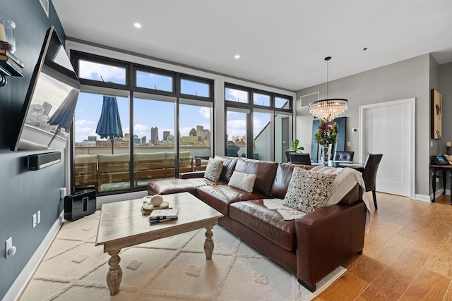 living room featuring an inviting chandelier and light wood-type flooring