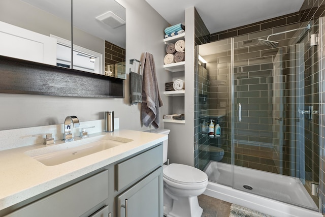 bathroom featuring tile patterned floors, walk in shower, vanity, and toilet