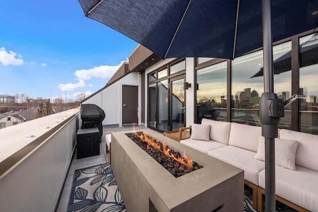 patio terrace at dusk featuring an outdoor living space with a fire pit and a grill