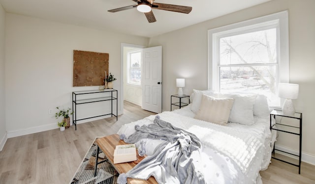 bedroom with light hardwood / wood-style flooring and ceiling fan