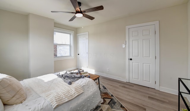 bedroom with light hardwood / wood-style flooring and ceiling fan