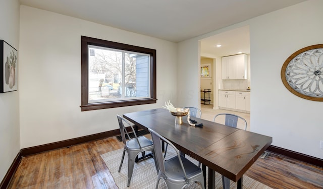 dining space with hardwood / wood-style floors