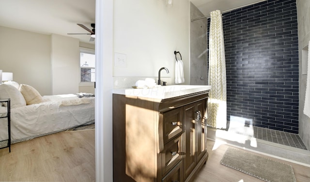 bathroom featuring hardwood / wood-style flooring, vanity, ceiling fan, and a shower with curtain