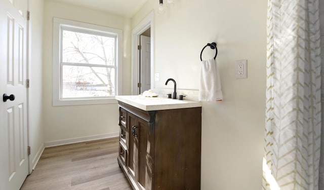 bathroom with plenty of natural light, vanity, and wood-type flooring