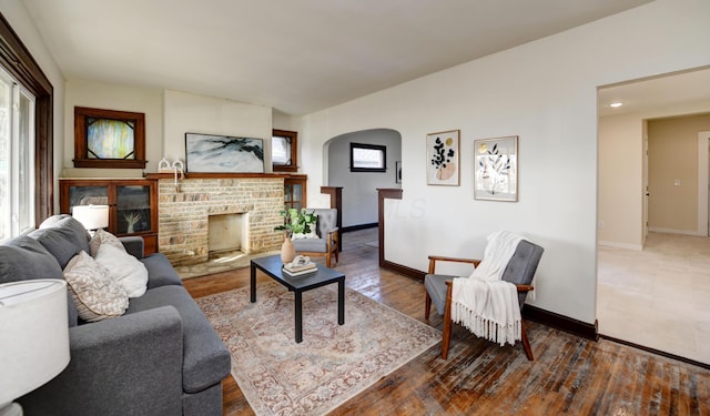 living room with a fireplace, hardwood / wood-style flooring, and a healthy amount of sunlight