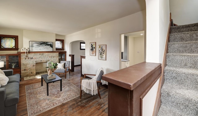 living room with a fireplace and dark hardwood / wood-style flooring