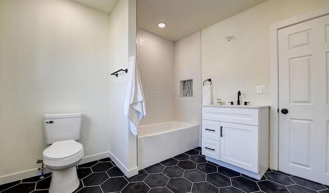 full bathroom with tiled shower / bath, vanity, and toilet