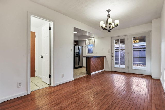 interior space featuring a notable chandelier and light wood-type flooring