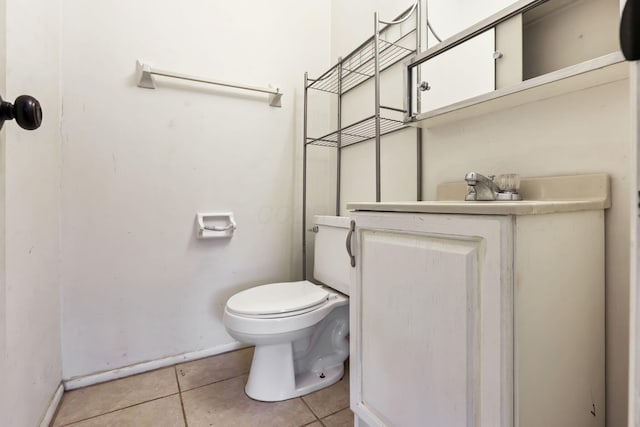 bathroom with tile patterned flooring, vanity, and toilet