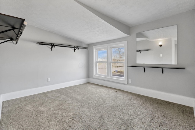 interior space with a textured ceiling and vaulted ceiling