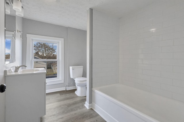 full bathroom featuring vanity, plus walk in shower, toilet, a textured ceiling, and wood-type flooring