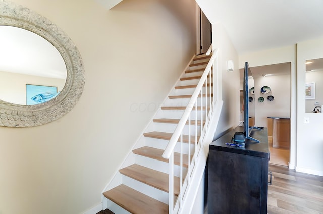 stairway with hardwood / wood-style floors