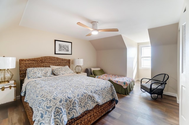 bedroom featuring ceiling fan, dark hardwood / wood-style flooring, and lofted ceiling