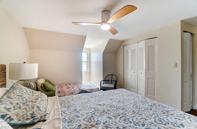 bedroom featuring ceiling fan, a closet, and lofted ceiling